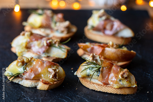 Christmas canapes made of pears, blue cheese and parma ham photo