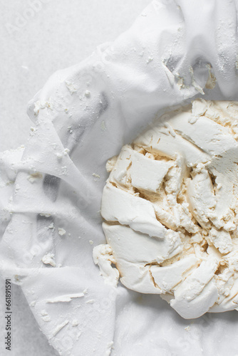 фотографія Greek yogurt being strained in white cotton cloth, process of making Greek yogur