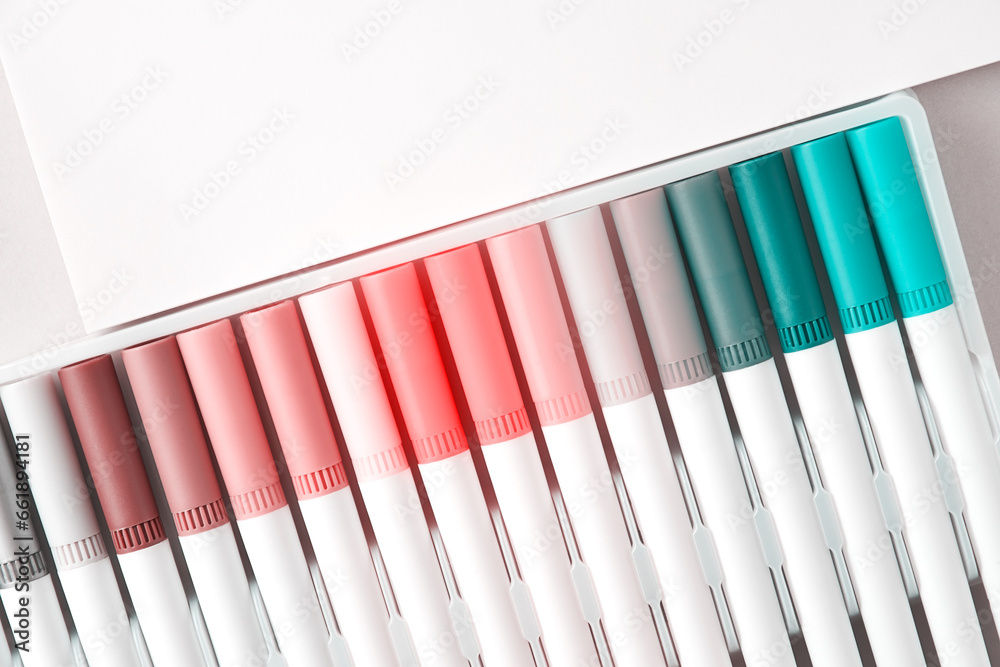 Pastel set of multicolored felt-tip pens, diagonal arrangement, white paper template. Pink and blue spectrum. Painting, arts, hobby. Copy space