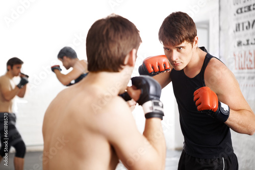 Foto Man, fighting and martial arts training for self defense techniques with sparring partner at dojo