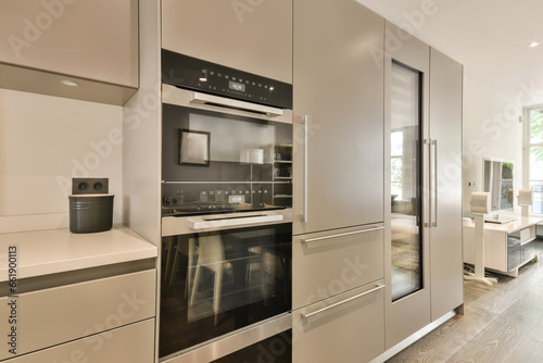 a modern kitchen with stainless steel appliances and an oven in the center of the photo is taken from the inside