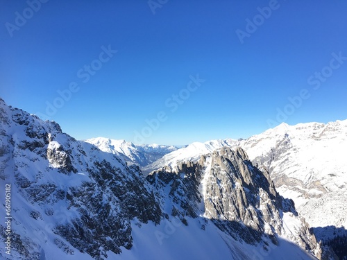 Snow covered mountains in EU. The beautiful blue clear sky  and white snow are stunning. © mukkam.art