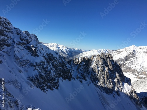 Clear sky and white snow are stunning. Snow covered allover on the mountains. The image was taken in Europe.