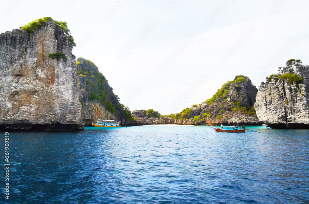 Island, ocean and mountains background for tropical, adventure and holiday with boats, journey and travel. Outdoor, nature and landscape of blue water, calm sea and rocks or cliff for secret vacation