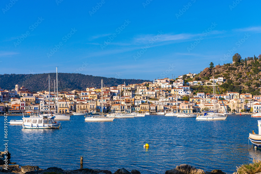Fototapeta premium Poros, Greece - 17 February 2023 - View on the town of Poros on Poros island seen from the mainland
