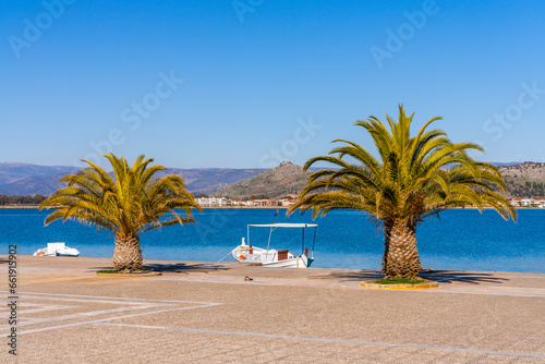 some empty fishing boats on the shore of the town of Nafplion on the Peninsula of Greece photo