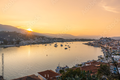 Poros, Greece - 17 February 2023 - Overview of the town of Poros on Poros Island and Galatas on the mainland at sunset