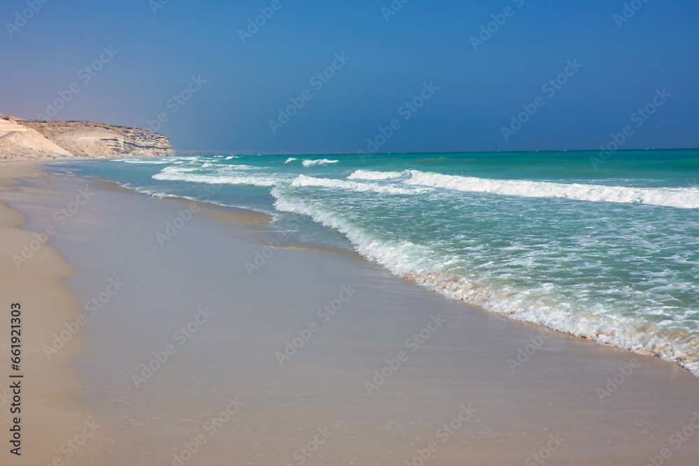 Turquoise Oman sea in the background mountains. Oman.