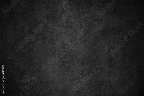 Textured black grunge background. Black concrete texture as a concept of horror and Halloween