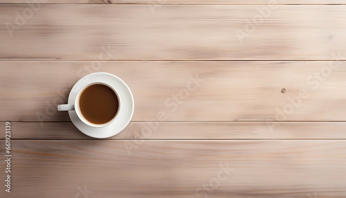 Coffee cup on wooden table background. Top view with copy space