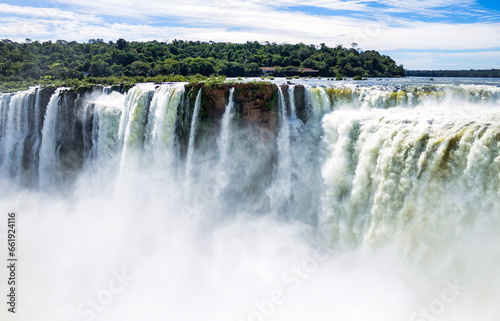 Devil's Throat of Iguazu (Iguacu) waterfall in Argentina, amazing sunshine falls landscape. Close up of view of majestic powerful water cascade, sunny day. World nature concept. Copy ad text space