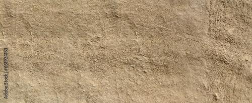 Clay wall of a clay house structure background. Brown clay mud grunge cement texture wall.