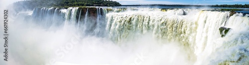 Panoramic view of sunshine falls landscape, Devil's Throat of Iguazu (Iguacu) waterfall in Argentina. Majestic powerful natural water cascade, summer sun day. World nature concept. Copy ad text space