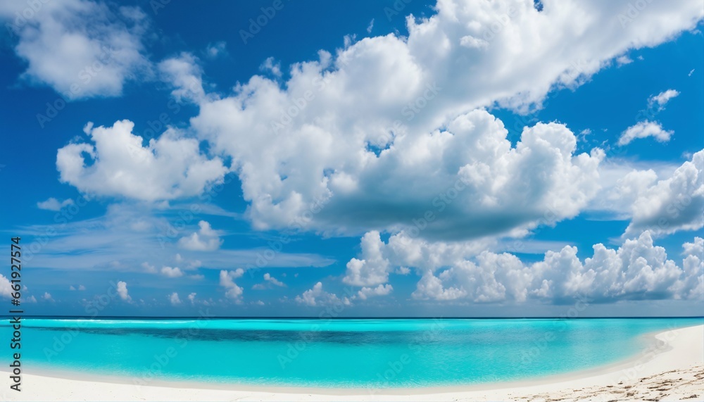 Sandy beach on sunny day with white sand and rolling calm wave of turquoise ocean, white clouds in blue sky background