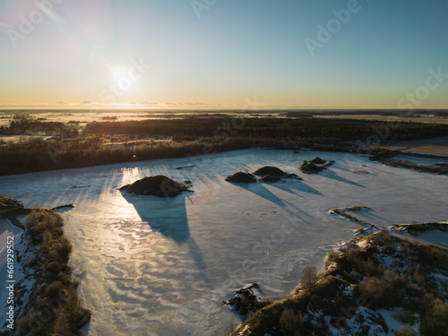 Winter in Estonia, frozen Maardu quarry early in the morning, photo from a drone. photo