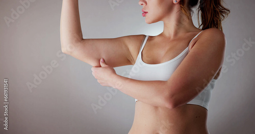 Close-up Of A Woman Holding Arm With Excess Fat photo