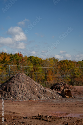 Pile of dirt with excavator bucket