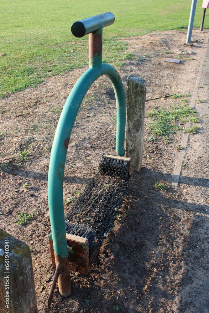 Brush shoe cleaner scraper at a outdoor football ground, used to remove mud and dirt from shoes