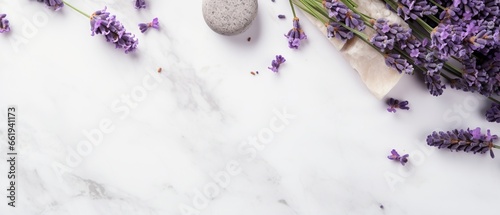 A delicate flat lay featuring lavender flowers and natural cosmetics, elegantly displayed on a sophisticated marble background, offering a soothing visual experience and empty space for versatile use.
