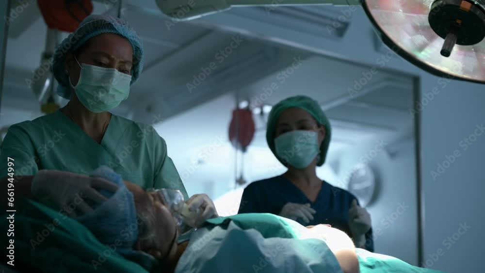 Doctor doing resuscitate a patient in oxygen mask resting on Bed in a hospital, CPR Cardiopulmonary resuscitation process