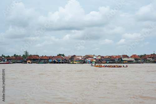 Two rowing teams in full speed during a competition on Musi river, Palembang, Indonesia. photo