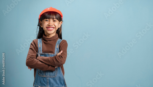 A little girl is wearing a engineer hat, is happy to learn. © Cheangchai