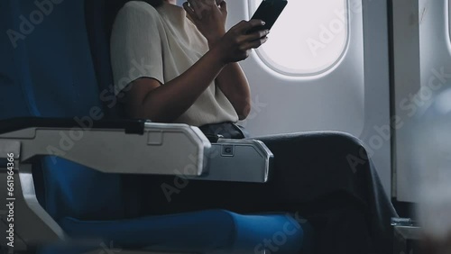 portrait of A successful asian business woman or female entrepreneur in formal suit in a plane sits in a business class seat and drink coffee during flight, relax concept photo