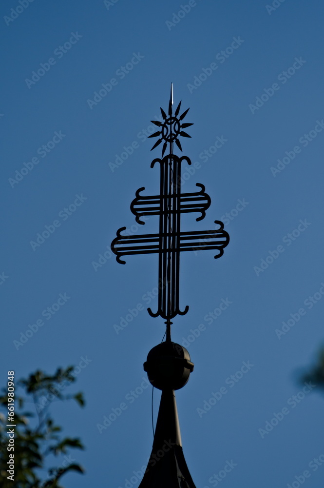 Religion symboles on the top of a church in Slovenia near to lake Bohinj. Metal double cross. Religion symboles on the top of a church in Slovenia near to lake Bohinj. Metal double cross.