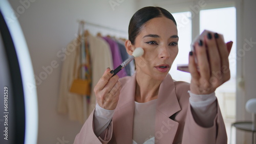 Visage influencer applying powder recording beauty blog. Makeup artist talking