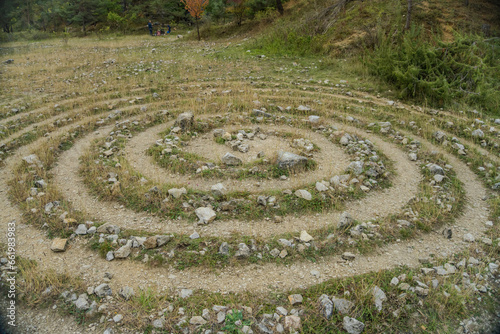 Circular labyrinths on the ground of grass and stones near the Konepruske cave.