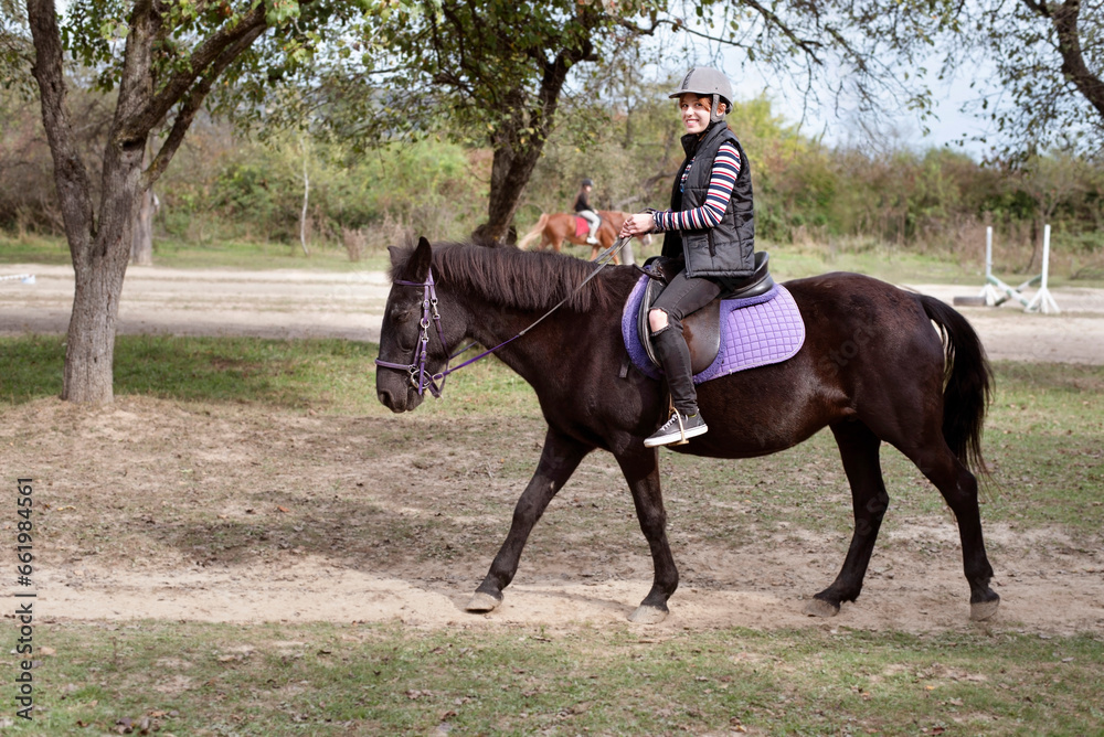 A teenage girl rides a horse in educational rehabilitation center, a girl needs hippotherapy after an injury, a girl rides a horse for first time, she starts to smile after a long depression A teenage girl rides a horse in educational rehabilitation center, a girl needs hippotherapy after an injury, a girl rides a horse for first time, she starts to smile after a long depression