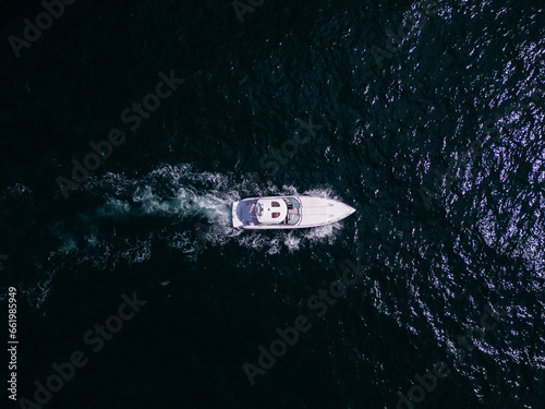 Aerial view of a pleasure boat racing through the sea waves, cre © sandsun