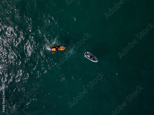 Aerial view of a personal watercraft speeding through the waves, creating a mesmerizing trail. photo