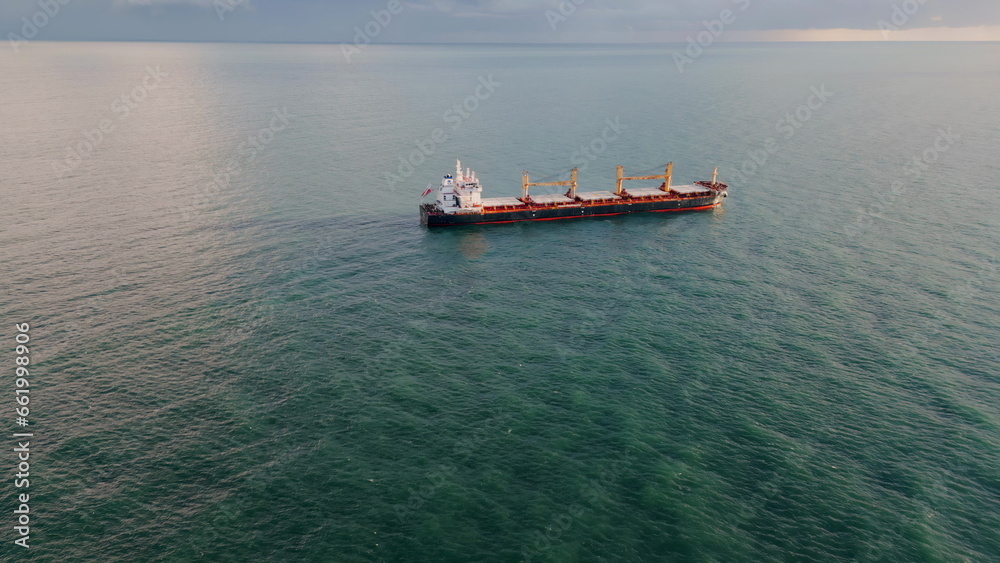 Aerial view cargo vessel sailing ocean to gloomy horizon. Tanker floating sea