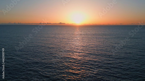 Orange sunset marine horizon landscape drone view. Sundown reflecting calm water