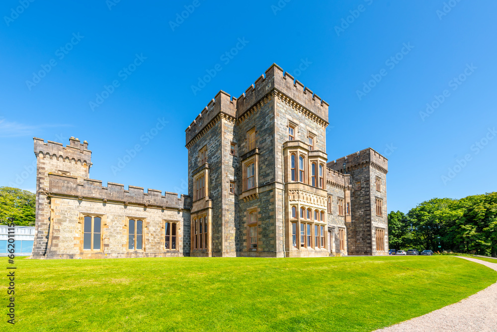 Fototapeta premium The historic Lews Castle looks out over the harbor port of the village of Stornoway, Scotland, on Lewis and Harris Island in the Outer Hebrides.