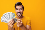 Man success rich cash business money dollar hand surprised happy yellow background smiling finance currency