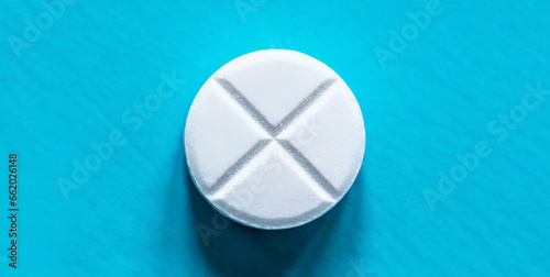 one pill on light blue background top view 
