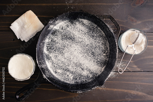 Greased and Floured Cast-Iron Skillet: Frying pan coated with vegetable oil and dusted with all-purpose flour to prevent sticking