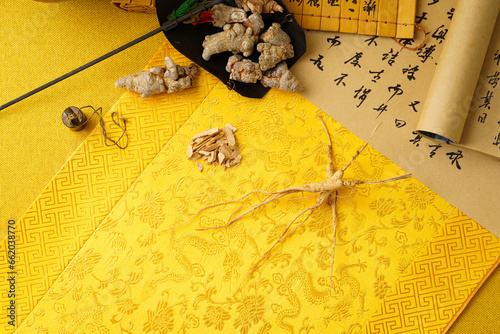 Traditional Chinese medicine ginseng on a golden background photo