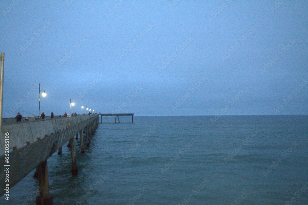 pier in the sea with fishermen