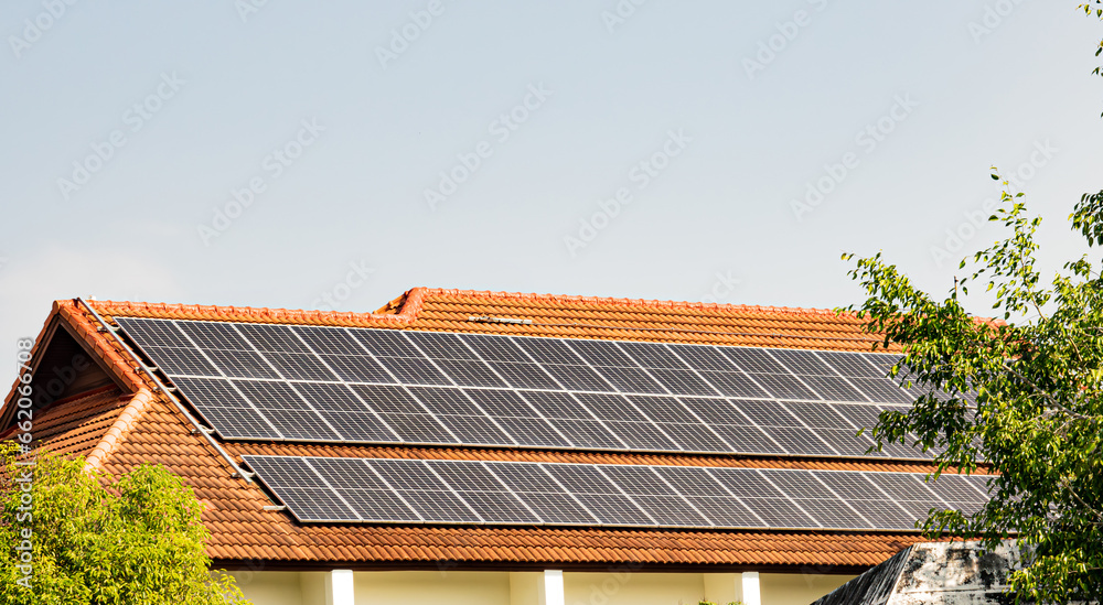 Fototapeta premium Solar panels on the roof top of a factory building , Solar panels on a roof of industrial warehouse
