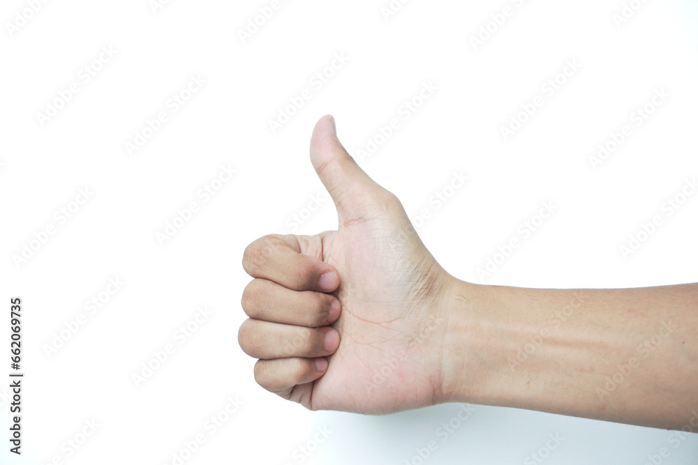 Closeup of male hand showing thumbs up sign against white background Closeup of male hand showing thumbs up sign against white background