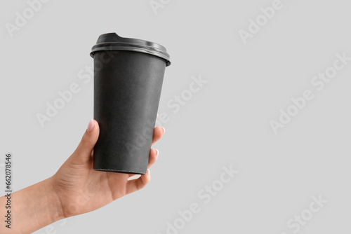 Female hand with black take...