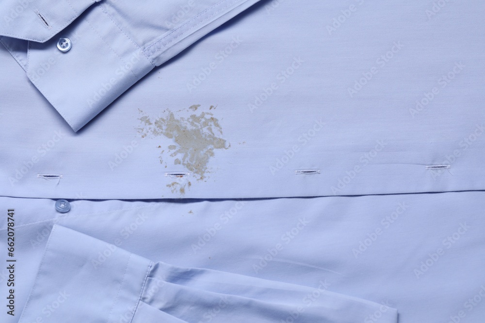 Closeup view of light blue shirt with stain