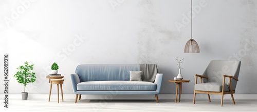 Scandinavian sofa and velvet armchair in an elegant white grey and blue living room With copyspace for text