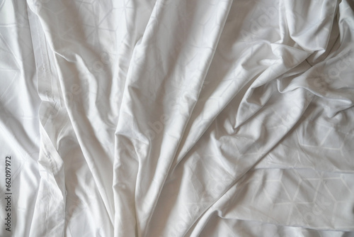 Fototapeta Naklejka Na Ścianę i Meble -  Top view of wrinkles on an unmade bed sheet 