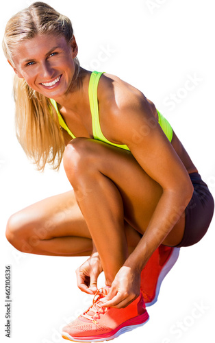 Digital png photo of happy caucasian woman tying shoelaces on transparent background