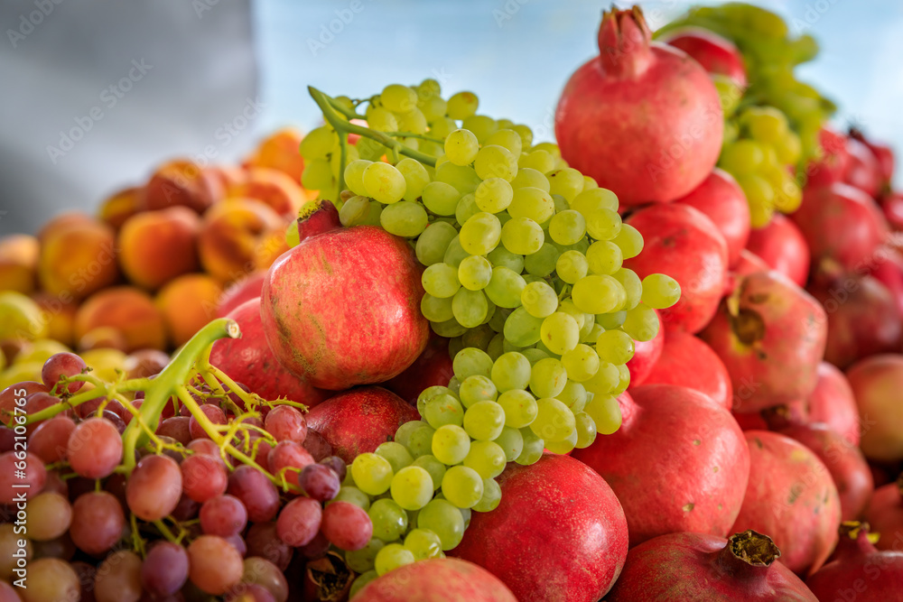 Fresh grapes and pomegranates in crates sold in bulk at a farmers market in San Francisco, California Fresh grapes and pomegranates in crates sold in bulk at a farmers market in San Francisco, California