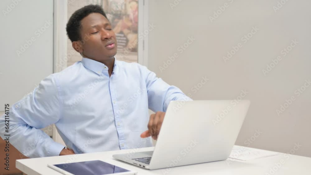 African Businessman having Back Pain in Office African Businessman having Back Pain in Office